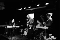 a black and white photo of a band on stage